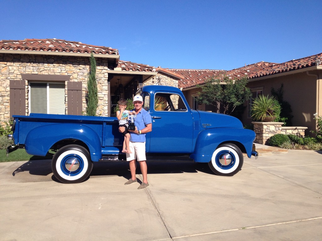 Kevin Laney with his grandson in front of the award winning Mariner blue 1950 Chevy pickup 